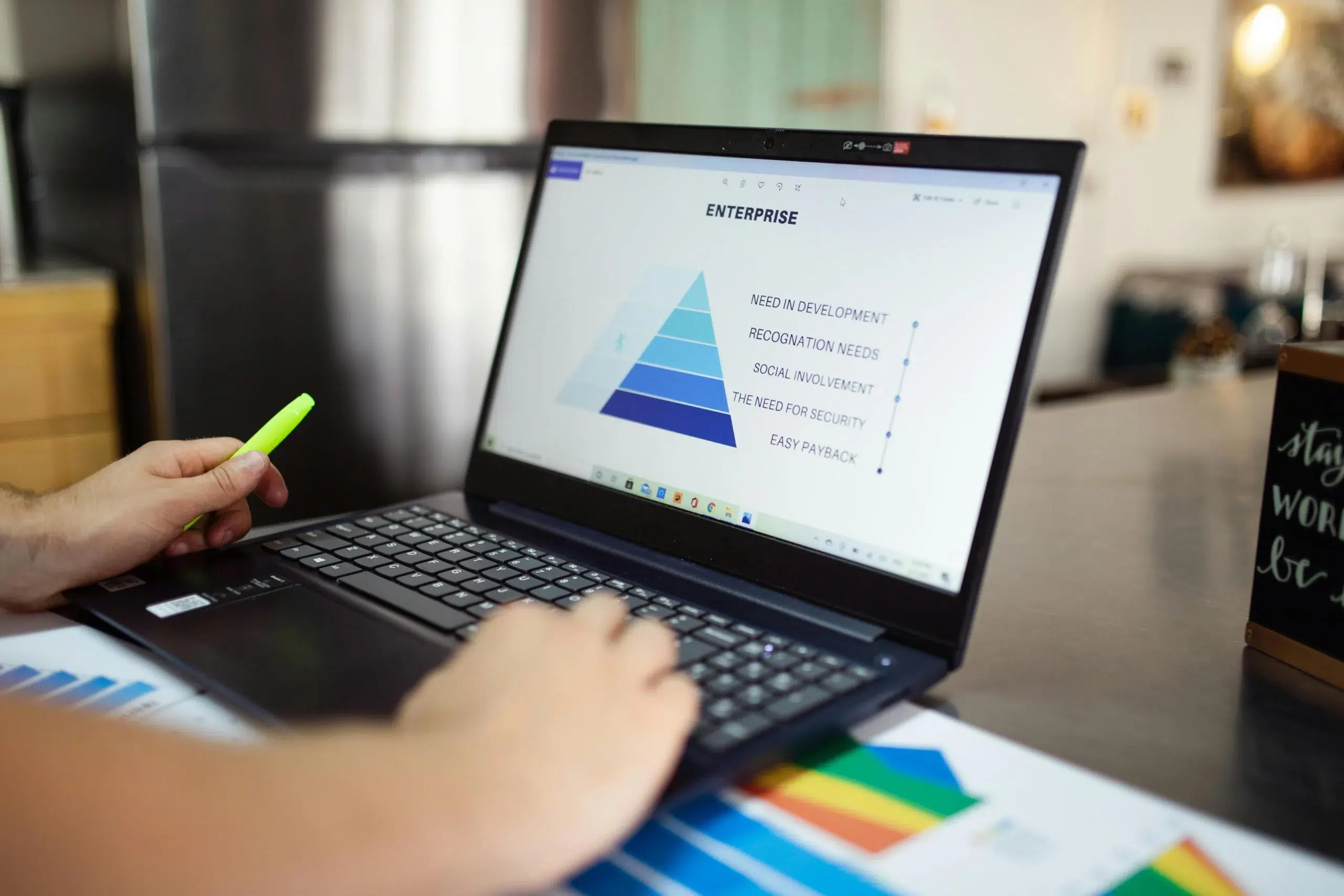 A person using a laptop displaying an enterprise hierarchy chart, representing real-time analytics and data-driven decisions in ERP systems.